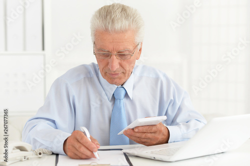 Portrait of confident senior businessman working in the office