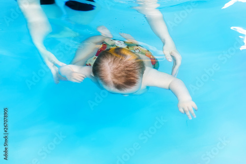 The outline of a child floating under water