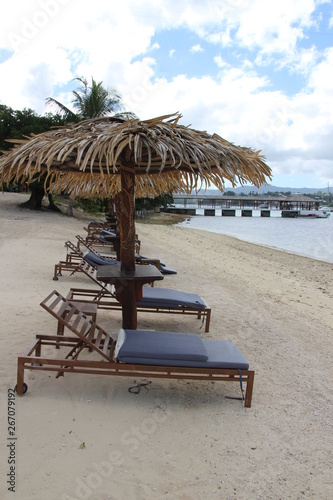 beach with lounge chairs and umbrellas