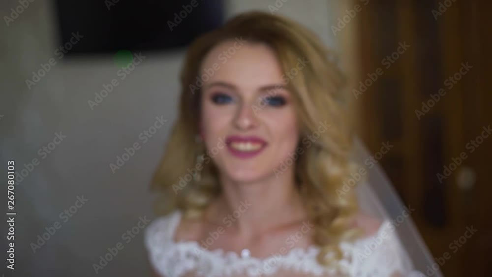Young woman smiles and posing at the camera, and showing dress. Slow motion Young woman smiles and posing at the camera, and showing dress. Slow motion