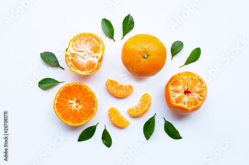 Orange fruits and green leaves on a white background.