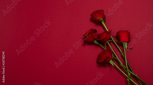 Send flowers online concept. Flower delivery for valentine and mother day. Bouquet of red roses isolated on red background. Post card design with beautiful nature rose. Top view. copy space.
