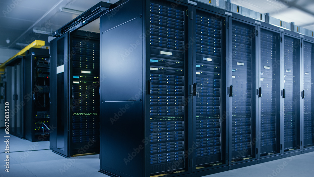Shot of Data Center With Multiple Rows of Fully Operational Server Racks. Modern Telecommunications, Cloud Computing, Artificial Intelligence, Database, Super Computer Technology Concept. Shot of Data Center With Multiple Rows of Fully Operational Server Racks. Modern Telecommunications, Cloud Computing, Artificial Intelligence, Database, Super Computer Technology Concept.
