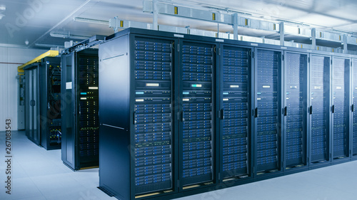 Shot of Data Center With Multiple Rows of Fully Operational Server Racks. Modern Telecommunications, Cloud Computing, Artificial Intelligence, Database, Supercomputer Technology Concept. photo