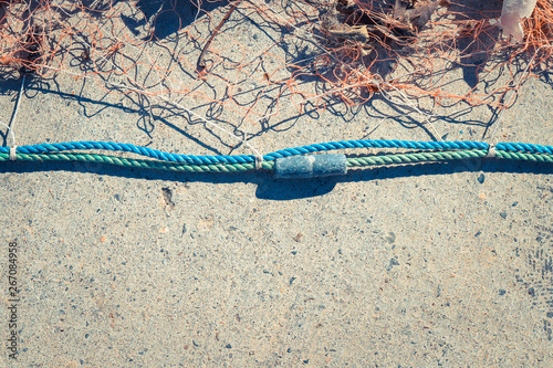 Valokuva Fishnet with sinker on rope. Nautical marine background.