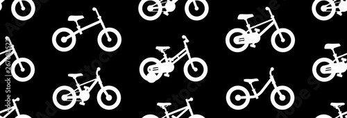 Seamless pattern with Kids bicycles. isolated on black background