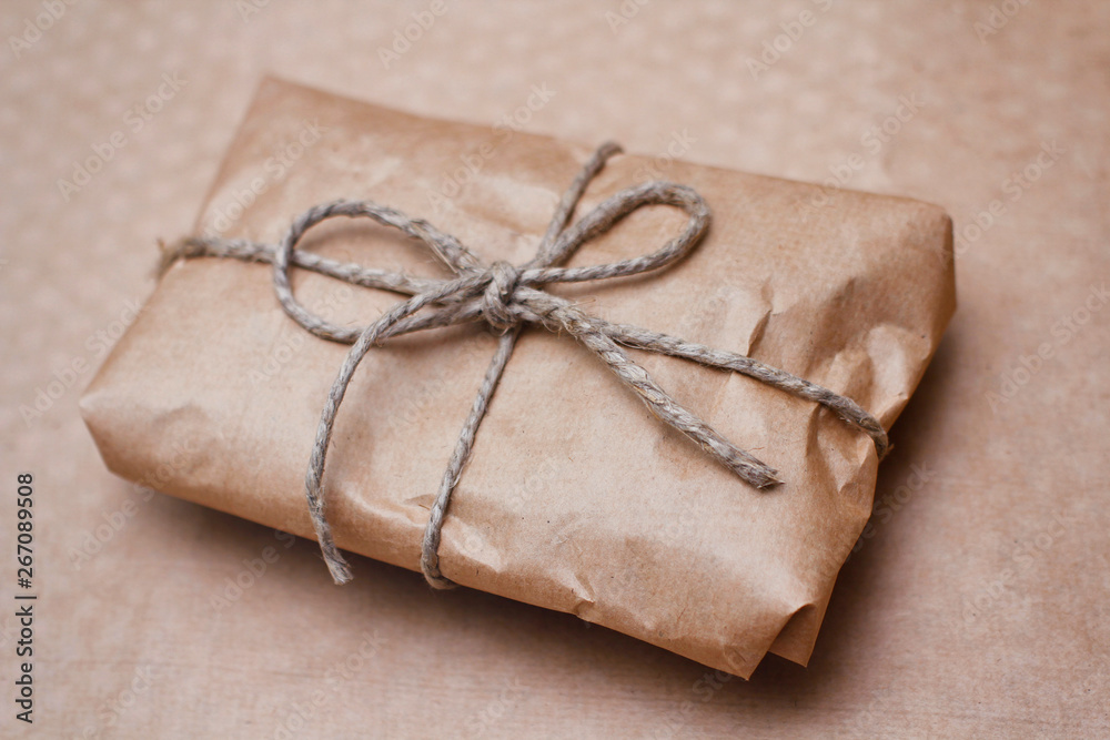 Parcel wrapped by brown craft paper and tie hemp thread. 