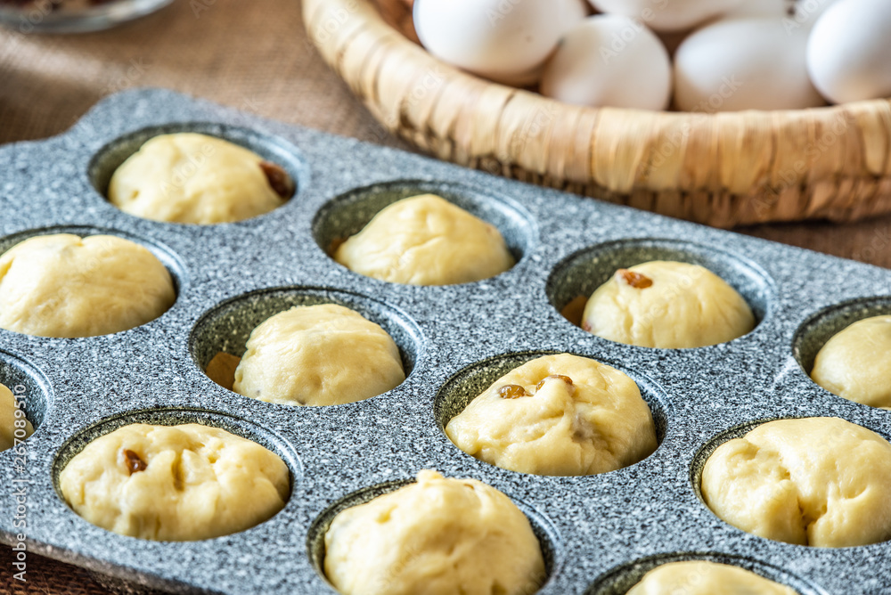 Filling a cake baking pan with dough