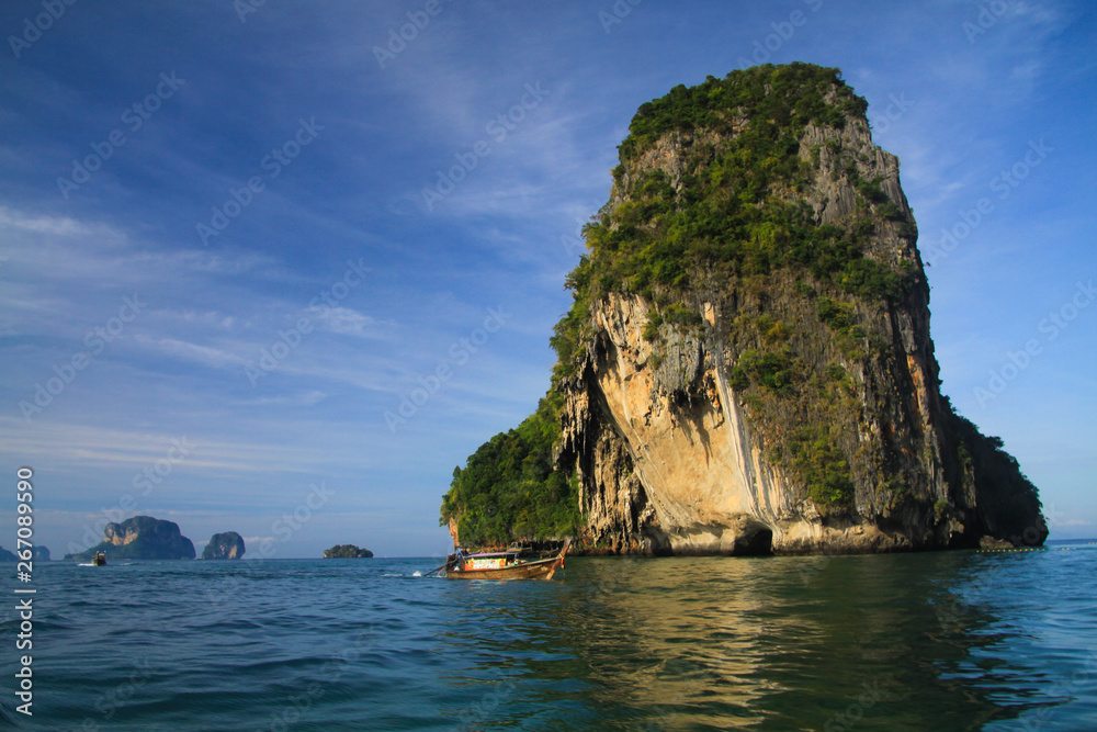Lonely isolated limestone rock in a deep blue Andaman sea near Ao Nang, Krabi, Thailand