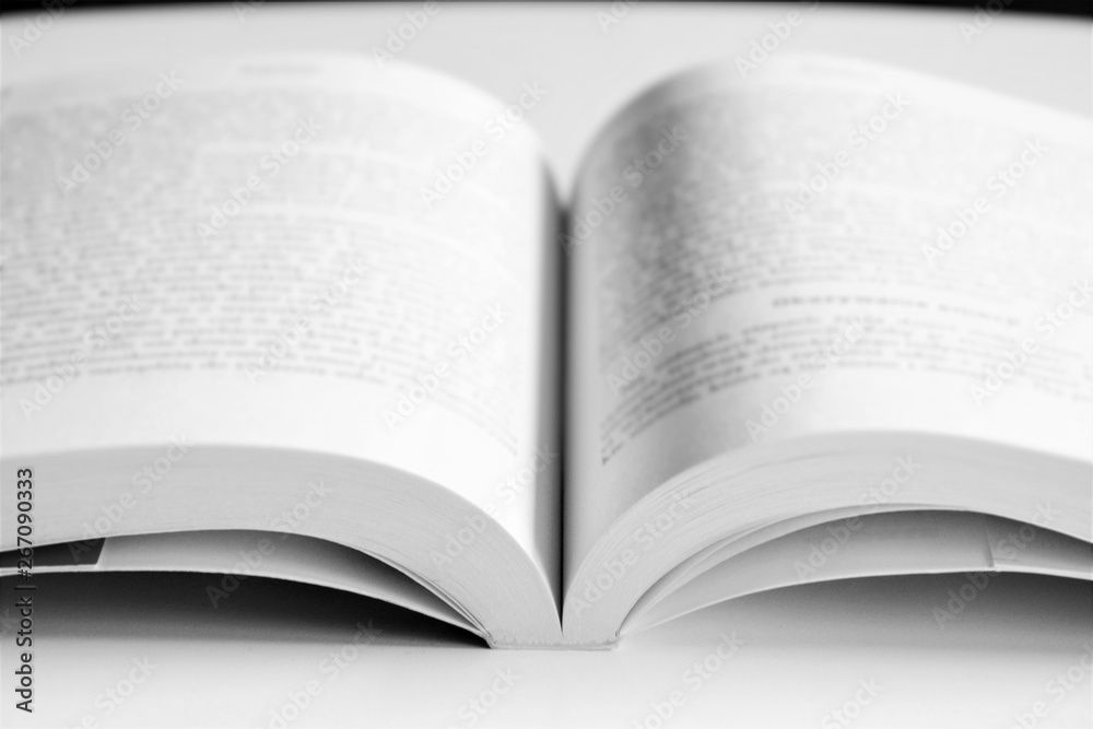 Opened book on the table. Intentionally blurred image, out of focus. Opened book on the table. Intentionally blurred image, out of focus.