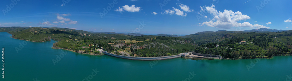 Aerial drone photo of famous lake and dam of Marathon or Marathonas with beautiful clouds and blue sky, North Attica, Greece