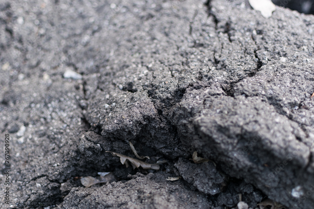 Old asphalt with cracks. The texture of the damaged pavement. Old asphalt with cracks. The texture of the damaged pavement.