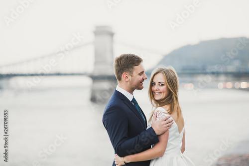 Kissing wedding couple staying over beautiful landscape © olegparylyak