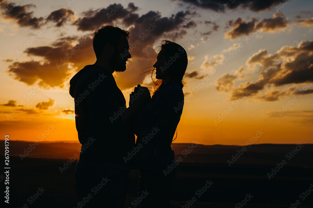 Silhouette of a loving couple at sunset