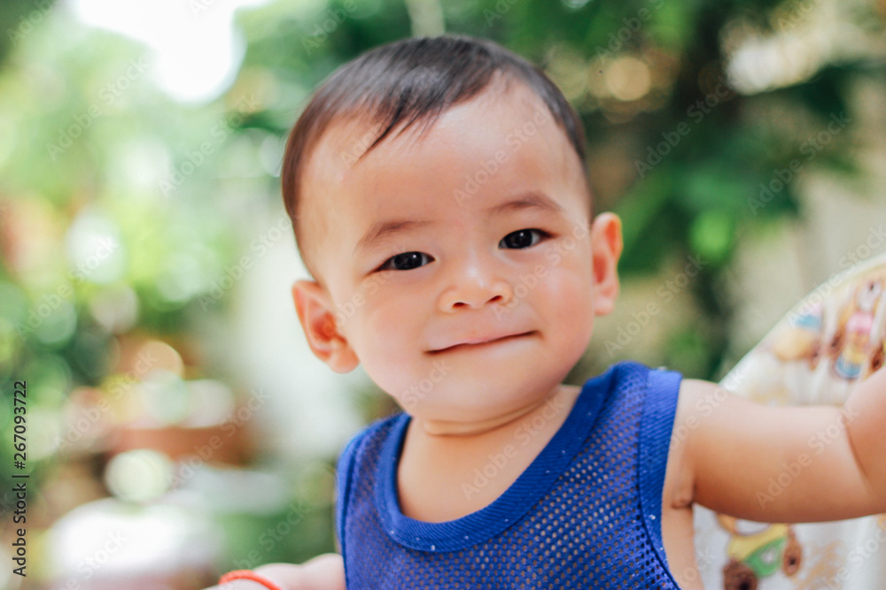 baby smiling and looking up to camera outdoors in sunlight baby smiling and looking up to camera outdoors in sunlight