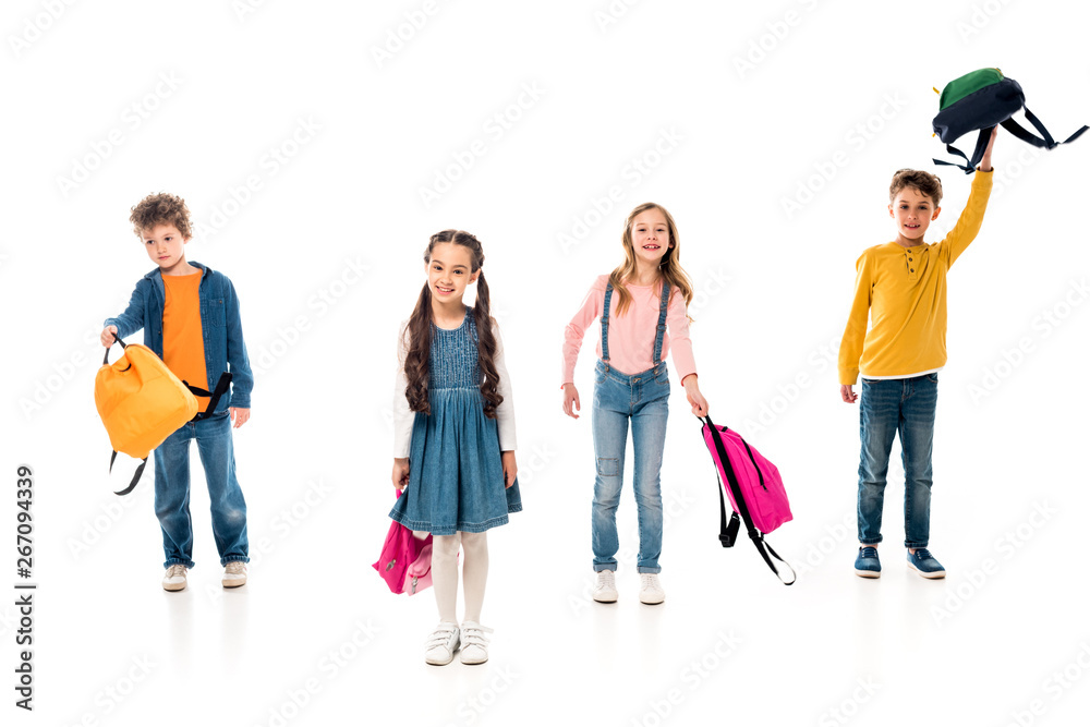 full length view of schoolkids with backpacks on white full length view of schoolkids with backpacks on white
