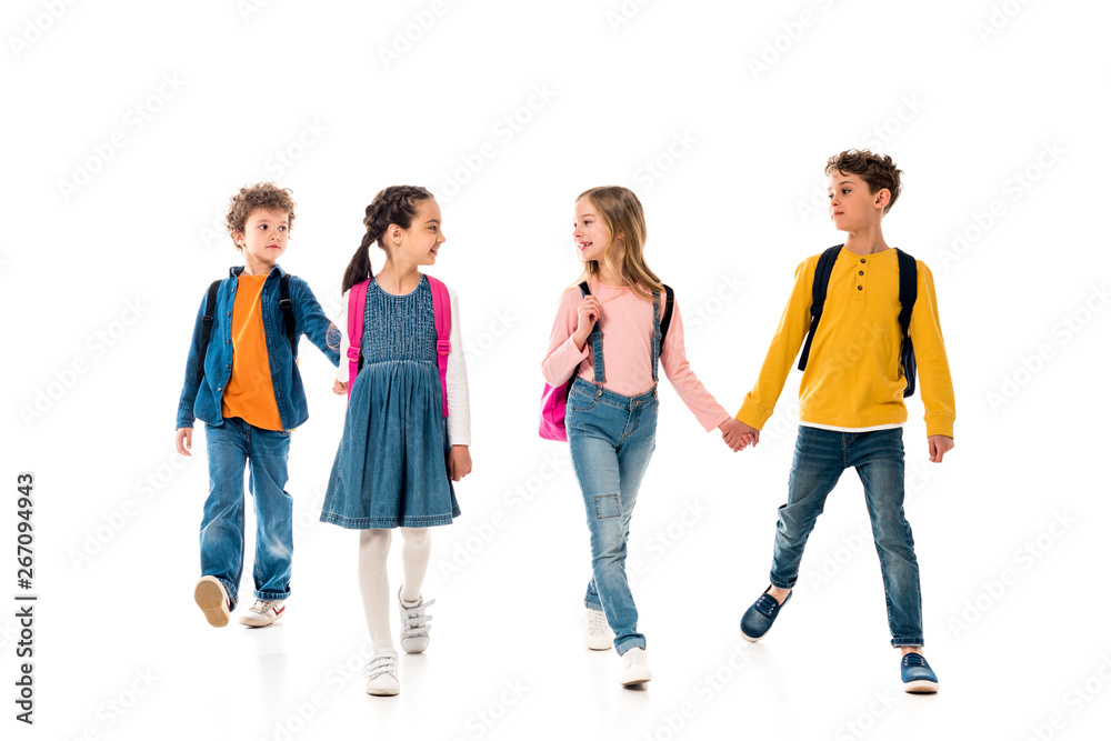 full length view of schoolchildren holding hands isolated on white full length view of schoolchildren holding hands isolated on white