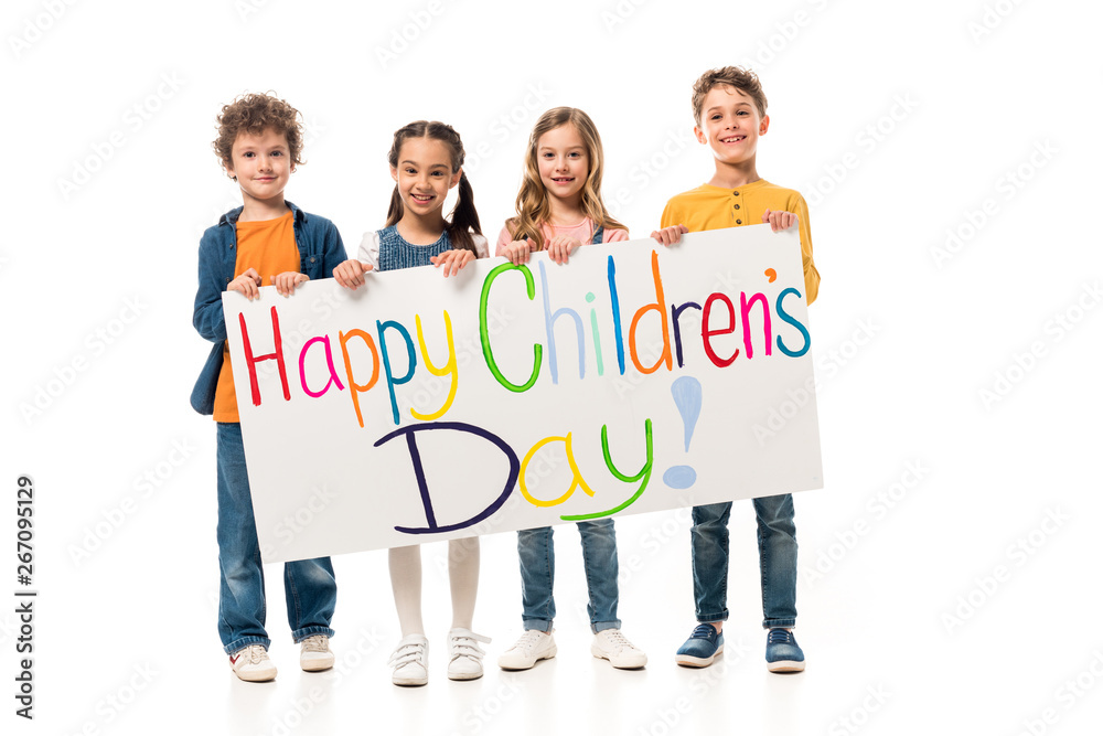 Obraz premium full length view of smiling kids holding placard on white