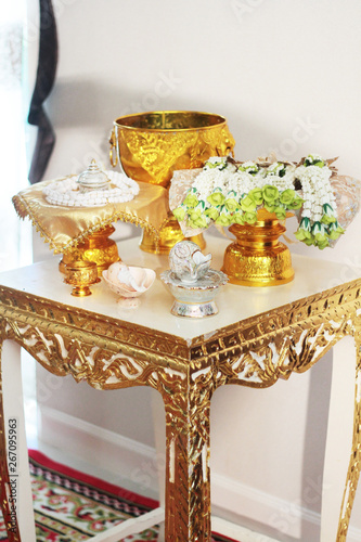 Conch shell on glod tray and Flower garlands on a gold tray decoration on gold bowl for Thai engagement ceremony.Thai wedding culture tradition