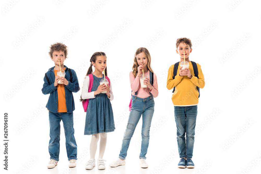 full length view of schoolchildren drinking milkshakes isolated on white full length view of schoolchildren drinking milkshakes isolated on white