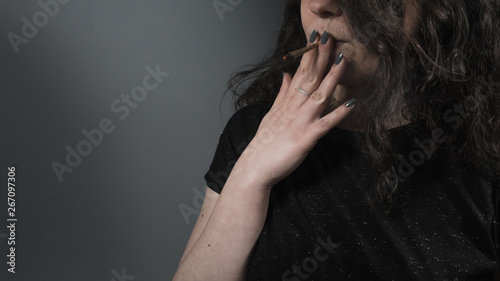 The young person smoking medical marijuana joint. Close-up.