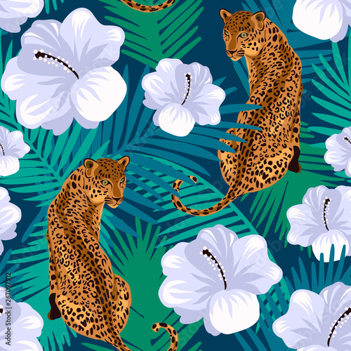 Floral jungle leopard seamless pattern. Animal print pattern with tropical leaves and flowers in deep blue background.