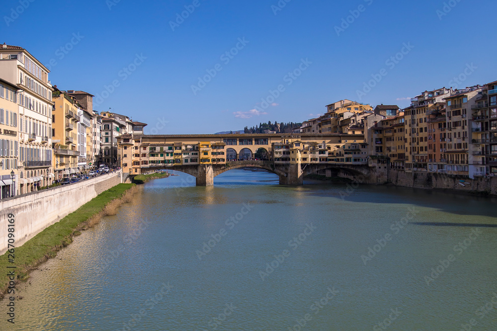 Sunny view on the Arno River and Ponte Vecchio in Florence, Italy