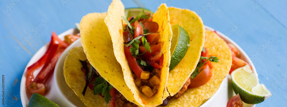 Mexican Tacos with Ground Beef and Vegetables on Rustic Blue Background Mexican Tacos with Ground Beef and Vegetables on Rustic Blue Background