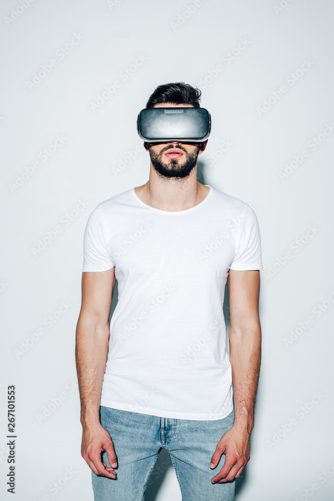 bearded man wearing virtual reality headset while standing on white bearded man wearing virtual reality headset while standing on white