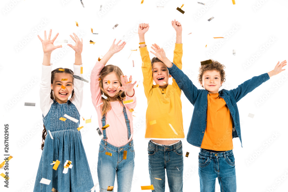 Obraz premium four happy kids waving hands under confetti isolated on white