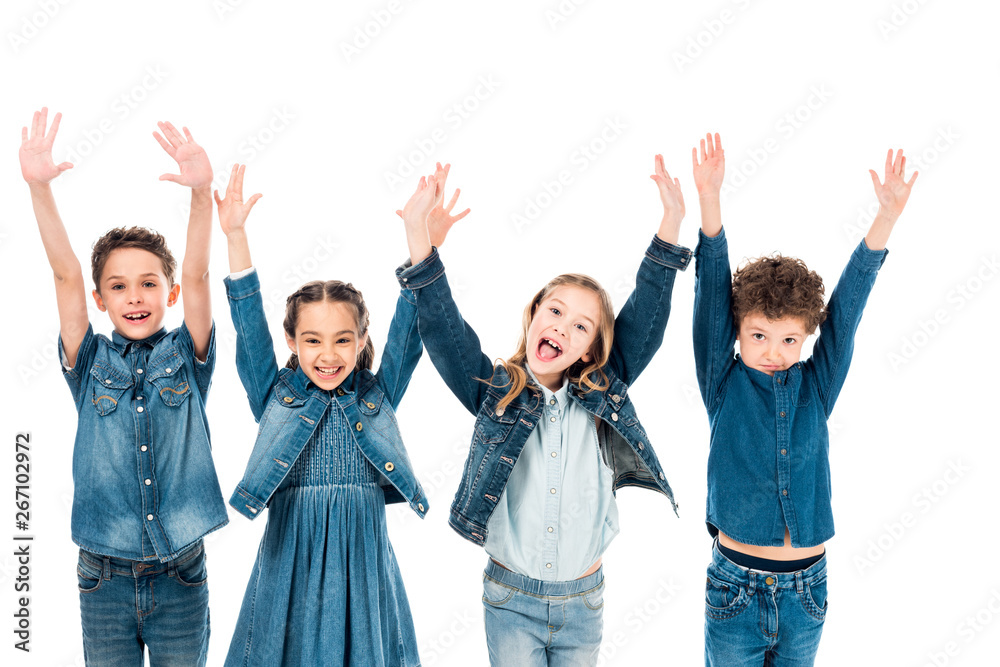 front view of four kids in denim clothes smiling with hands up isolated on white front view of four kids in denim clothes smiling with hands up isolated on white