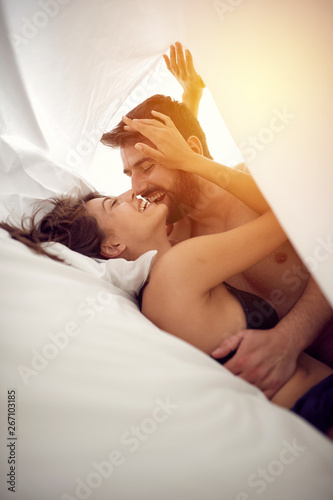 Couple in love having intimate sex in bed.