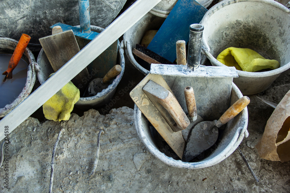 Preparation for construction work. Plastering tools the concrete to build  wall have Basket with Gyan plaster, trowel concrete plaster wood and  plastic, sponge. Stock Photo | Adobe Stock