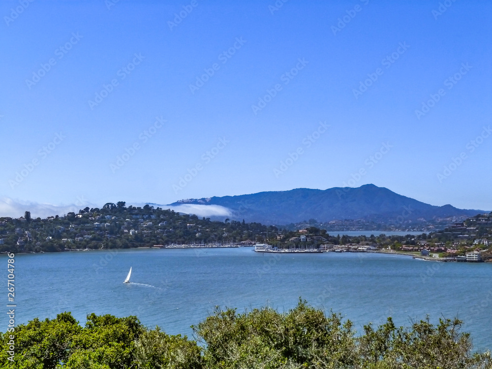 Skyline of Angel Island in San Francisco, California with sailboat and houses