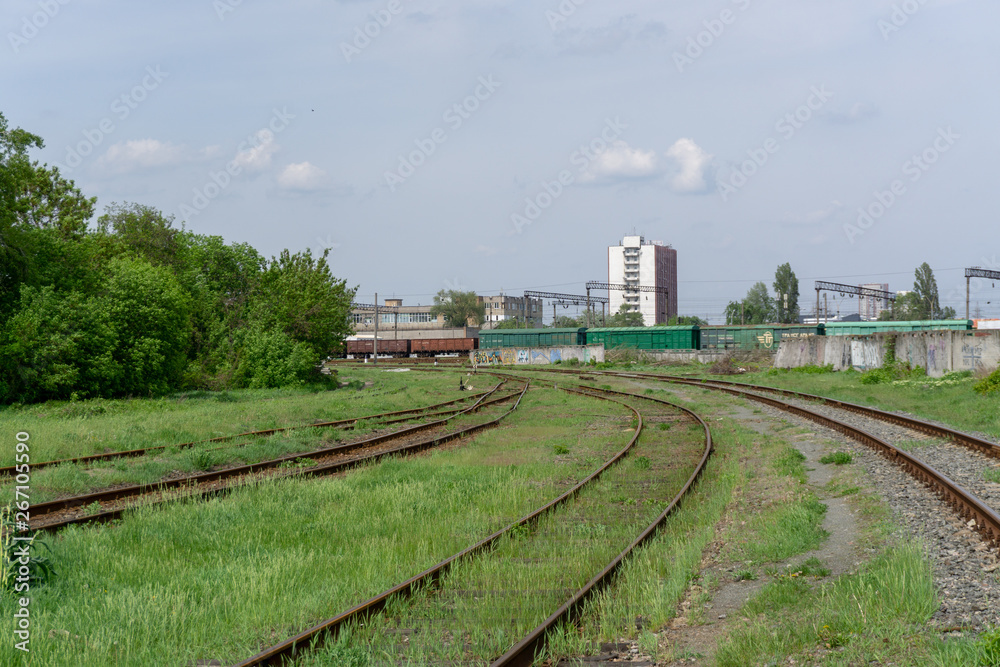 The railway passes through the city, sunny day with blue sky and clouds. Kyiv(Kiev), Ukraine. The railway passes through the city, sunny day with blue sky and clouds. Kyiv(Kiev), Ukraine.