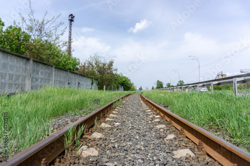 The railway passes through the city, sunny day with blue sky and clouds. Kyiv(Kiev), Ukraine.