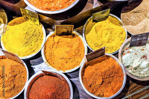 Fototapeta Naklejka Na Ścianę i Meble -  Many spices flat lay top view down on display in bowls trays filled with herbs, signs, curry, turmeric, mixes in store market bazaar