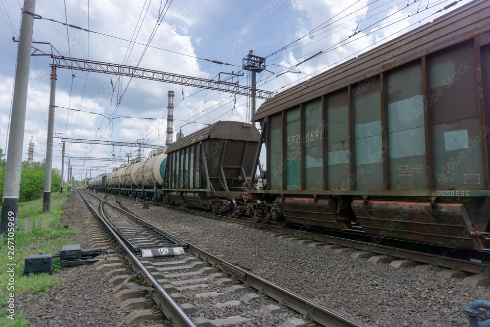 The train passes on a railway through the city, sunny day with blue sky and clouds. Kyiv(Kiev), Ukraine. The train passes on a railway through the city, sunny day with blue sky and clouds. Kyiv(Kiev), Ukraine.