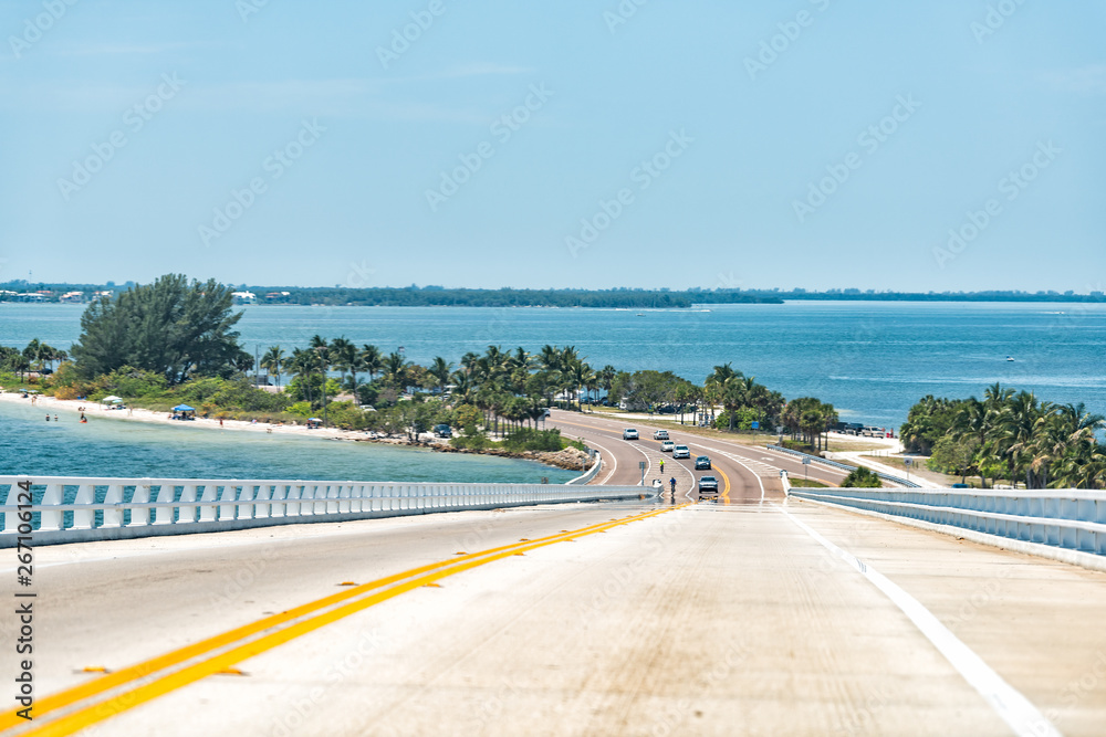Sanibel Island, USA bay during sunny day, toll bridge highway road causeway with colorful water and cars