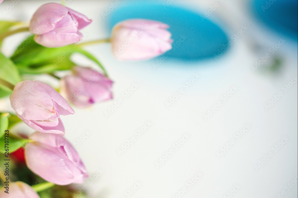Spring tulips in a vase on a kitchen table. Good beginning of the day. Morning mood. Spring concept. Sunny spring morning with flowers.