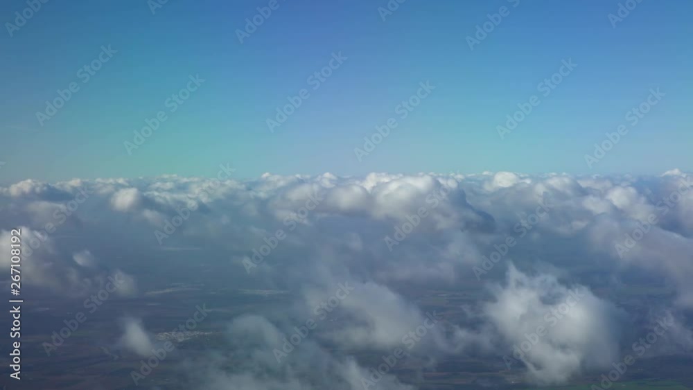 4K, Beautiful European country from above, as seen through airplane window. Passenger POV traveling by air. View of traveler in cabin at plane wing in flight trip with blue sky and clouds. -Dan 4K, Beautiful European country from above, as seen through airplane window. Passenger POV traveling by air. View of traveler in cabin at plane wing in flight trip with blue sky and clouds. -Dan