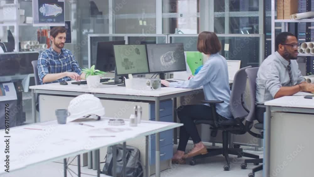 In the Busy Engineering Facility: Diverse Group of Engineers, Technicians, Specialists Working on Design for Industrial Engine Prototype. Professionals Talk, Work with Drawings, Use Computers