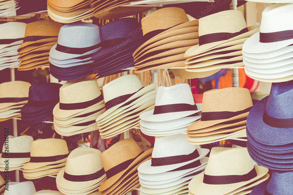 several straw hats in a flea market
