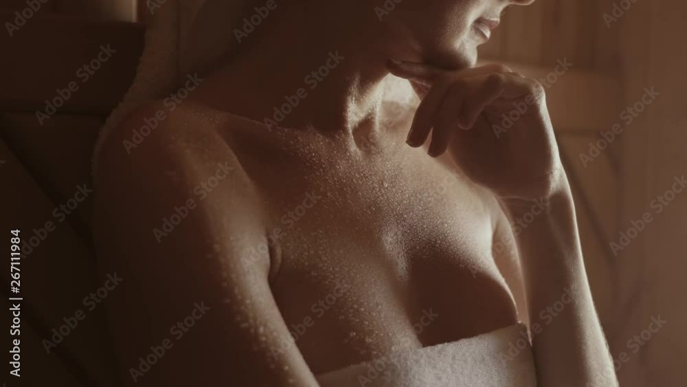 skin treatments in the sauna. a girl in a white towel on her head takes skin care procedures in a Finnish sauna. skin treatments in the sauna. a girl in a white towel on her head takes skin care procedures in a Finnish sauna.