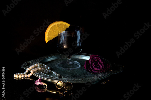 Wallpaper Mural On a silver tray a glass of red wine with an orange slice. Near a pearl necklace and wedding rings. Concept - wedding anniversary Torontodigital.ca
