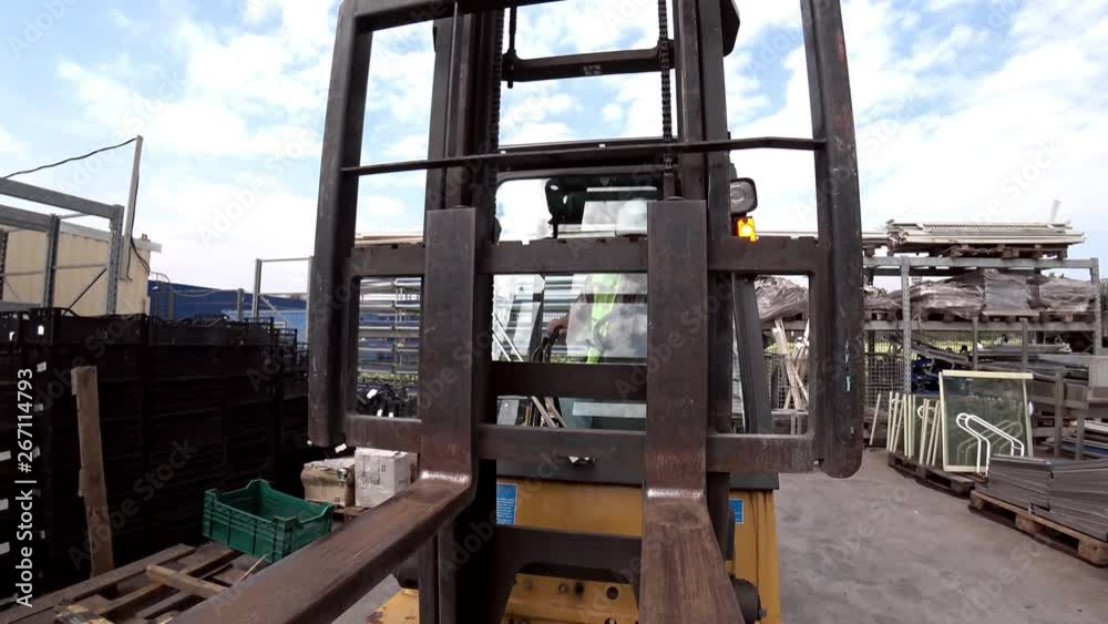 Working of the forklift on a warehouse outdoors. Working of the forklift on a warehouse outdoors.