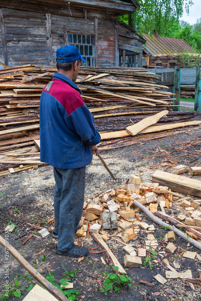 Worker cleans the area of forestry production Worker cleans the area of forestry production