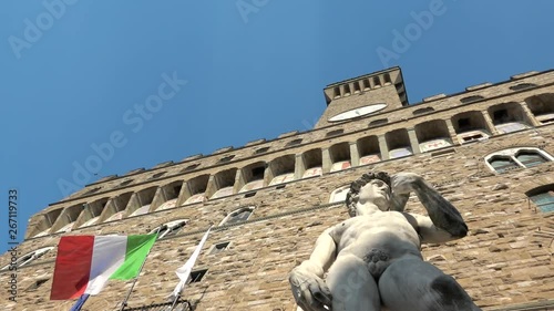 Famous David statue by Michelangelo in front of Palazzo Vecchio with Italian flag, Florence, Tuscany, Italy. Things to do in Italy, best place to visit, Firenze sightseeing, tourism destination
