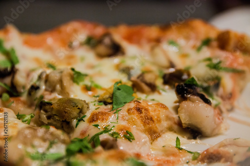 Pizza with seafood with melted cheese and herbs sprinkled on top