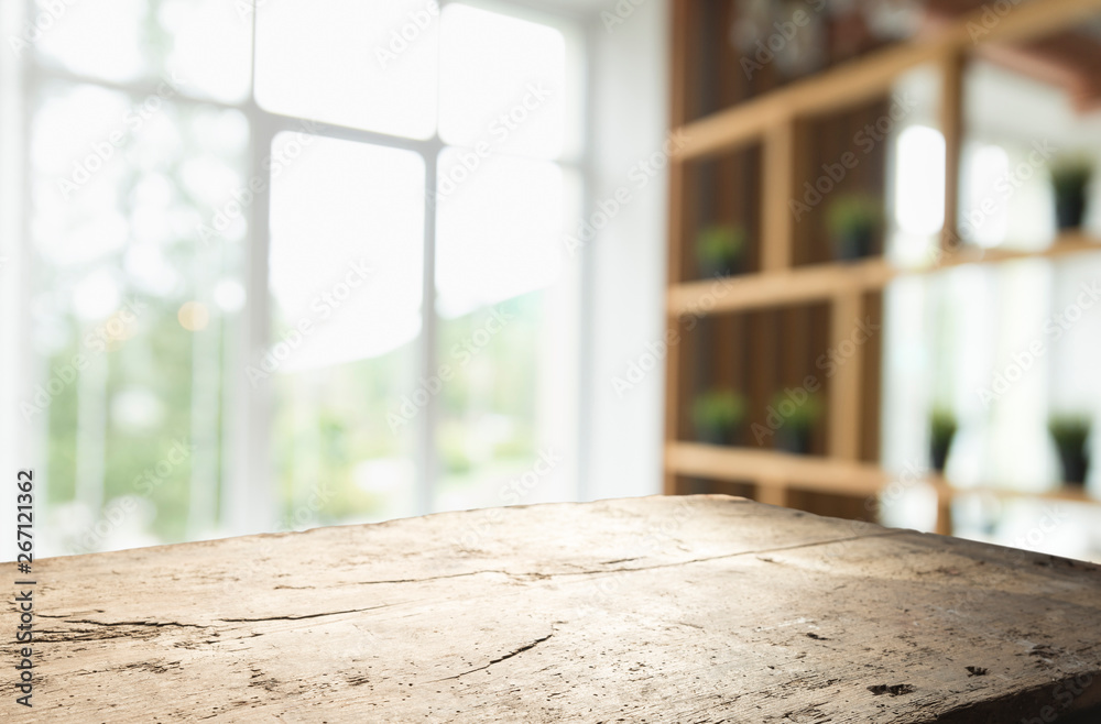 Wood table top on blur of window glass and abstract green from garden with city view in the morning background. For montage product display Wood table top on blur of window glass and abstract green from garden with city view in the morning background. For montage product display